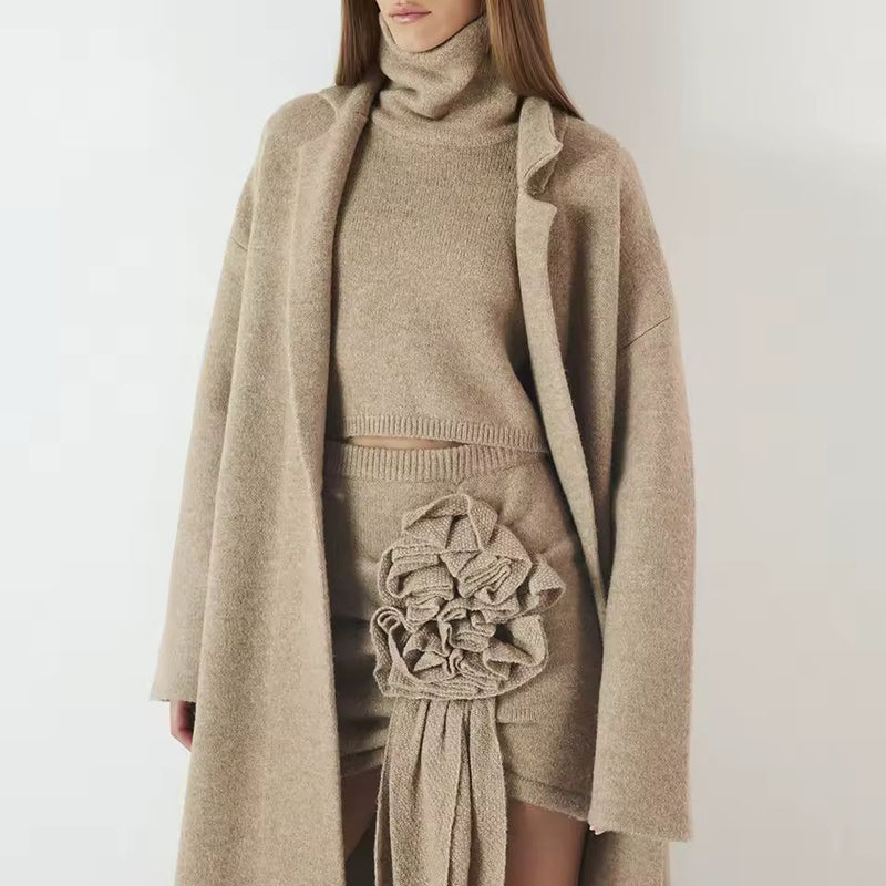 Elegant women’s knitwear set in beige – long wool blend coat, turtleneck sweater and midi skirt with ruffle detail, autumn winter fashion outfit.