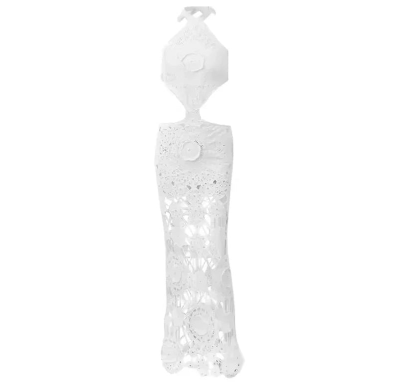 Elegant white crochet maxi dress with floral lace details, halter neckline, and side cut-outs.