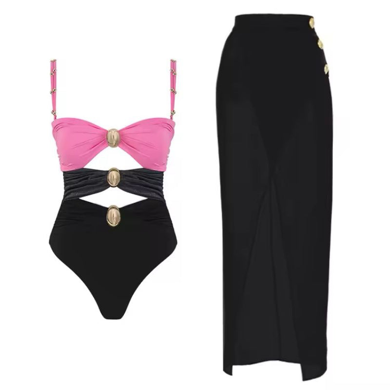 Luxury cut-out one piece swimsuit in bold pink with gold ring details and matching wrap skirt – Chic & Charm beachwear, seamless, wire-free, flattering fit for summer vacation or resort look.