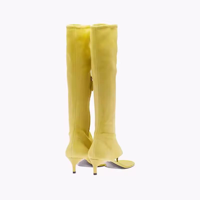 Yellow knee-high stretch boots for women with open toe and 7cm kitten heel, made from soft vegan PU leather, shown from side view.