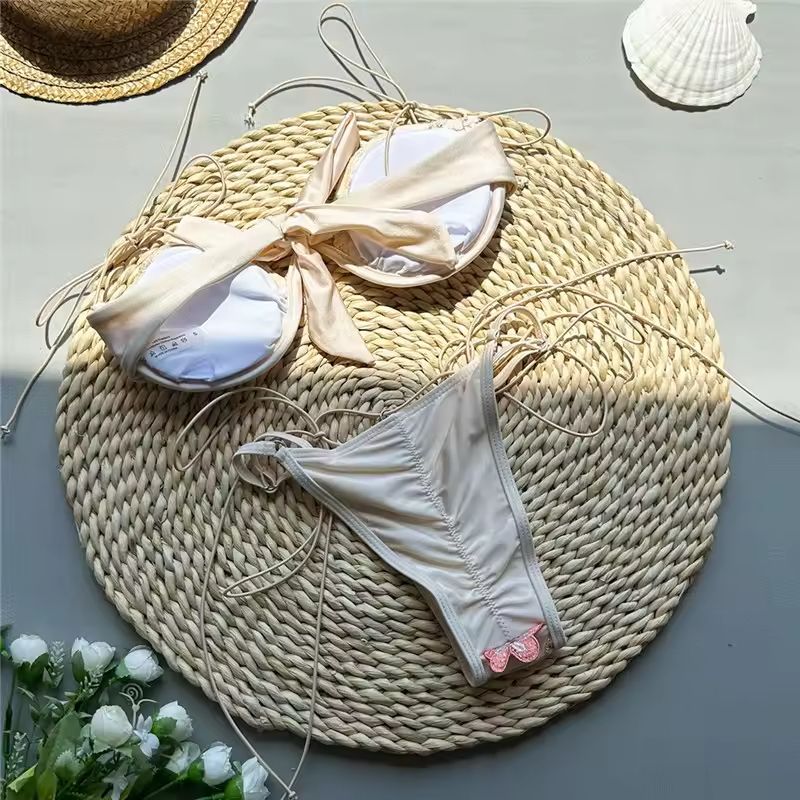 Embroidered push-up bikini for women with delicate floral details and adjustable thong bottoms.