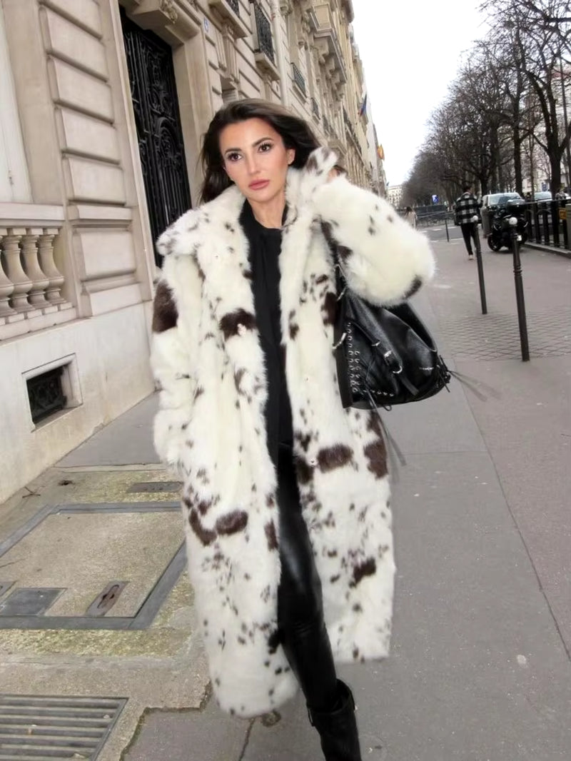 Long white faux fur coat with cow print, stylish women's outerwear, trendy faux fur coat, elegant fashion statement, chic casual coat, sustainable women's fashion, versatile winter coat.
