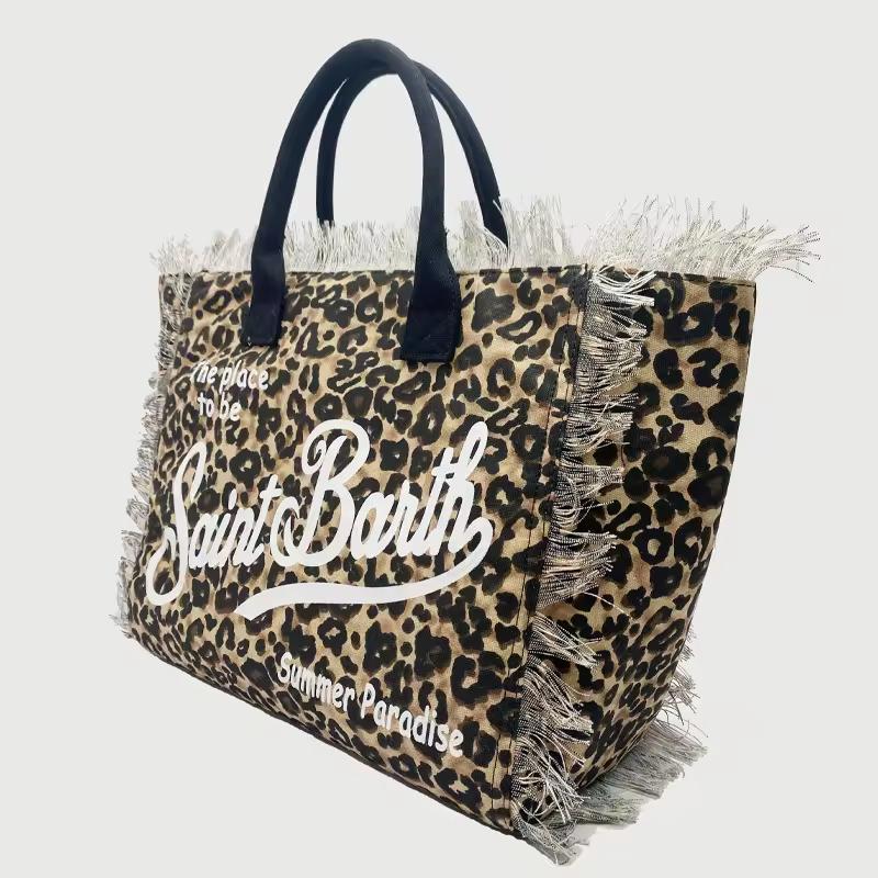 Saint Barth beach bags in hot pink, leopard print, ivory and natural straw – colorful canvas totes with boho vibe for summer 2025.