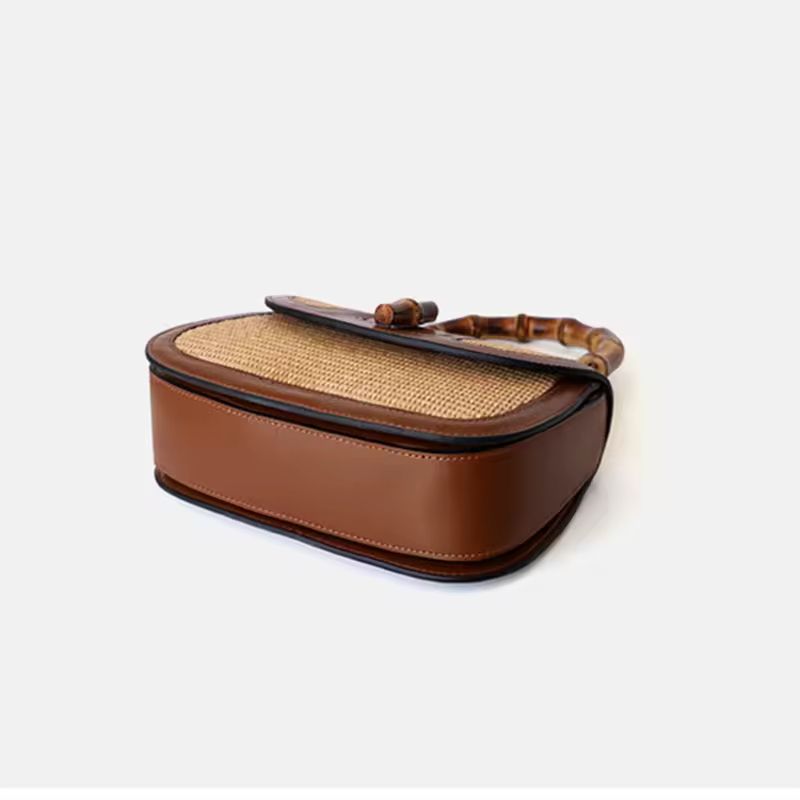 Side view of small bamboo handle handbag made from natural straw and genuine cowhide leather, adjustable shoulder strap, high-quality summer handbag for women – perfect everyday purse with boho style and luxury finish.
