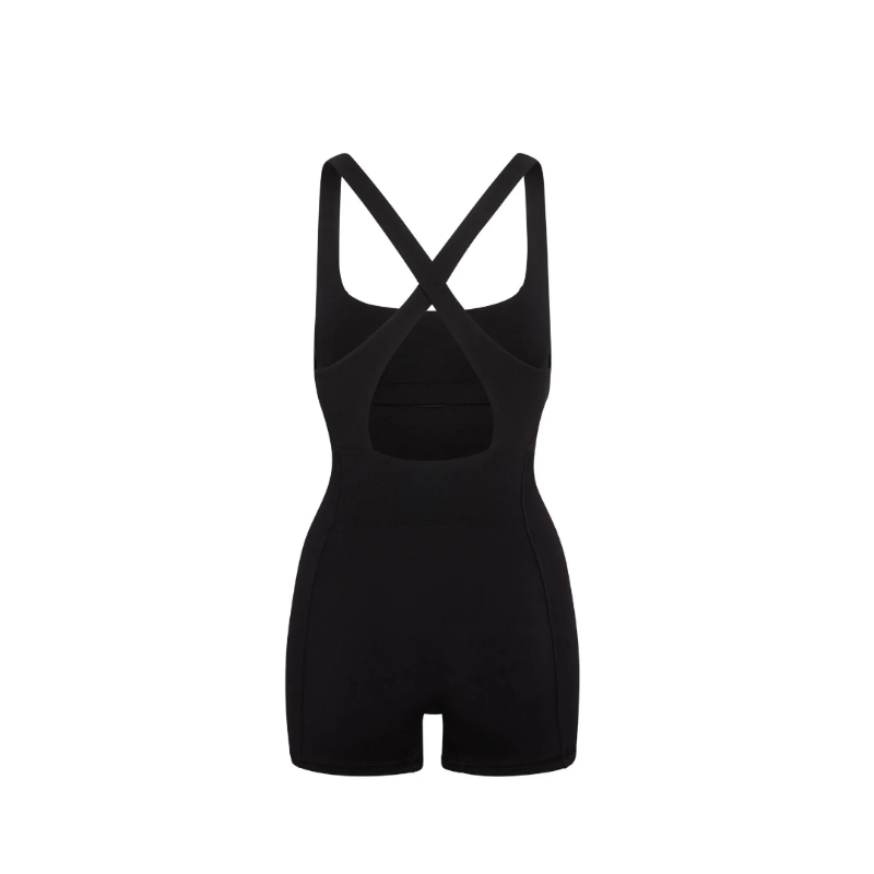 Black sculpting onepiece with cross-back straps and elegant cutout detail, made from a stretchy polyester-elastane blend, ideal for activewear and casual styling.