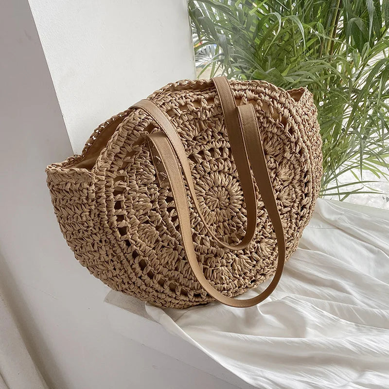 Handmade round boho straw bag with leather shoulder straps in beige