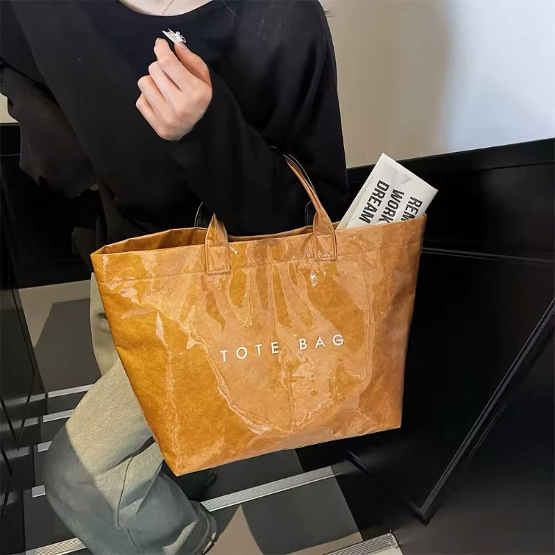 Brown jelly-style PVC tote bag with modern lettering – stylish large shoulder bag for shopping, market days, or moms on the go.