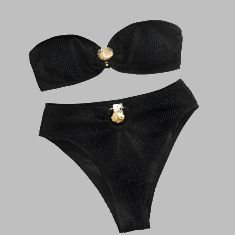 Luxury bikini in black with gold shell clasp, bandeau cut, and ribbed fabric.