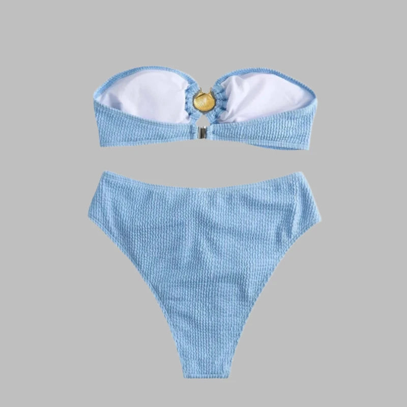 Luxury bikini in blue with gold shell clasp, bandeau cut, and ribbed fabric.