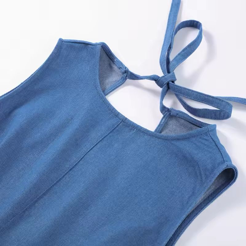 Chic women’s summer dress in light blue denim look – styled with heels and accessories