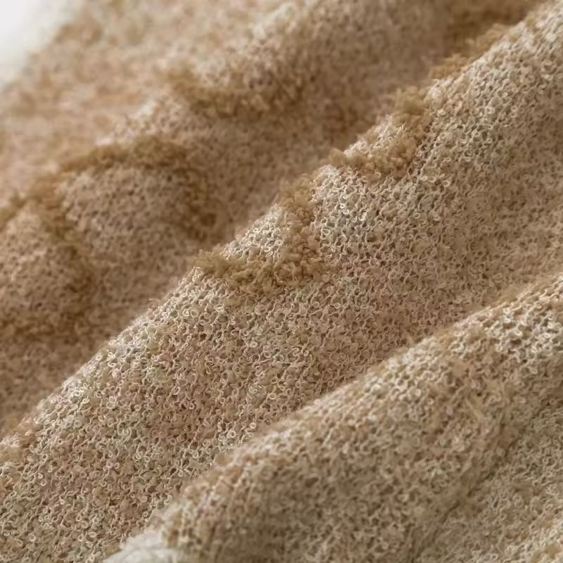 Back view of soft beige cropped knit vest with ribbed hem – minimal sleeveless sweater for women