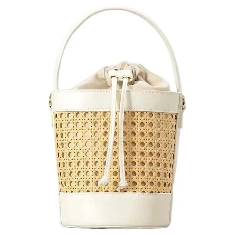 The CORA Straw Shoulder Bag styled on a picnic setup – the perfect accessory for beach days, weekend getaways and vacation looks.