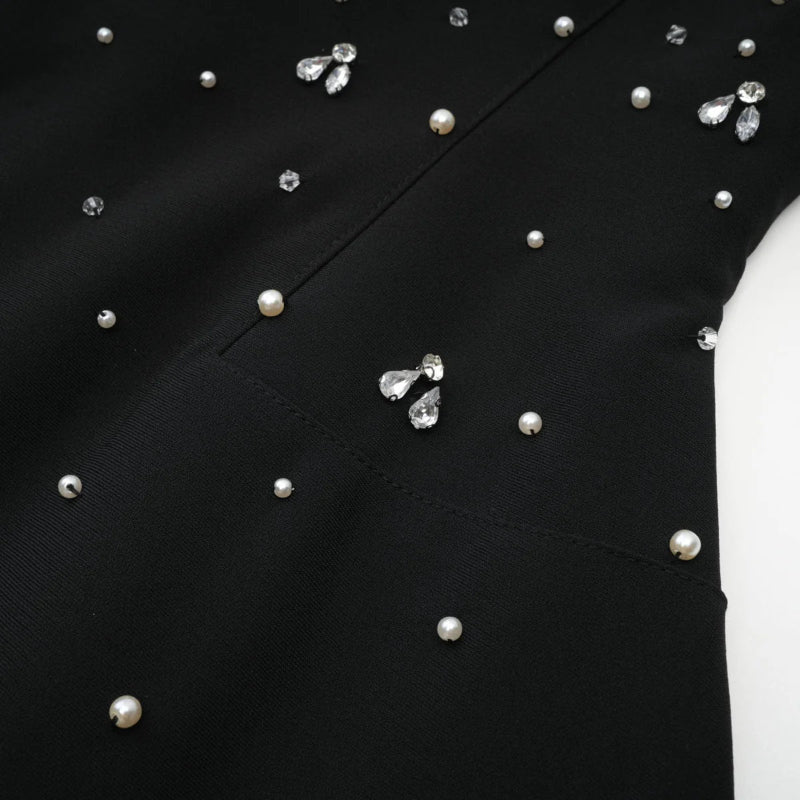 Close-up detail of pearls and crystals on Éclat de Lune black hand-embellished dress”