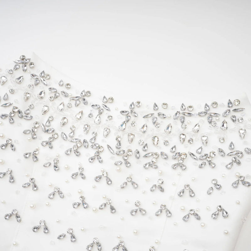 Close-up detail of pearls and crystals on Éclat de Lune black hand-embellished dress”