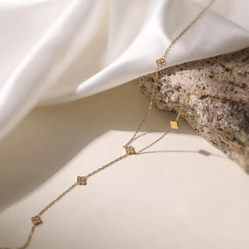 Delicate gold drop necklace with small crystal charms — elegant minimalist jewelry for everyday wear.