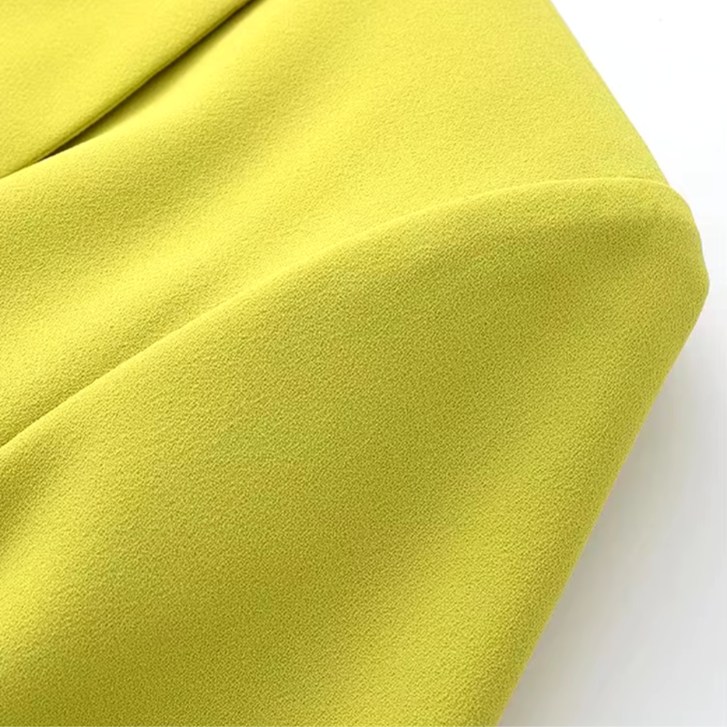 Bright yellow polyester wrap dress with tie waist, perfect for summer days or evening outings.