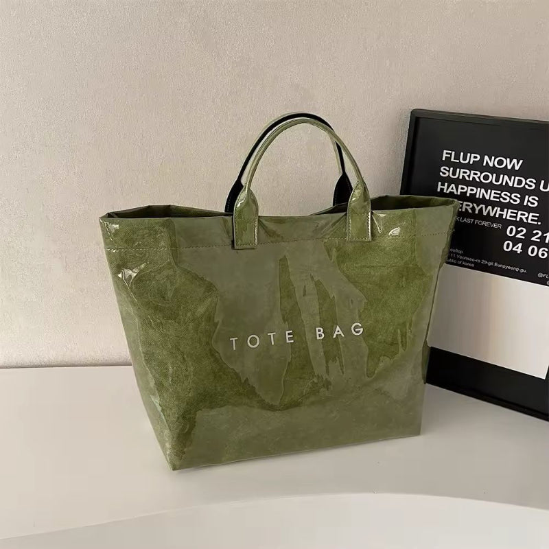 Green jelly-style tote bag with waterproof finish – trendy, lightweight PVC bag with bold lettering for beach, shopping or moms.