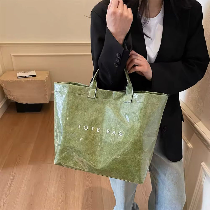 Green jelly-style tote bag with waterproof finish – trendy, lightweight PVC bag with bold lettering for beach, shopping or moms.