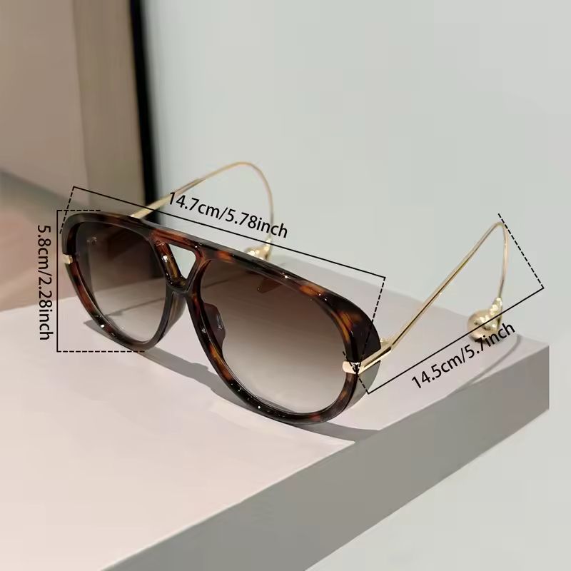Gold-arm tortoise sunglasses side view, fashion accessory.