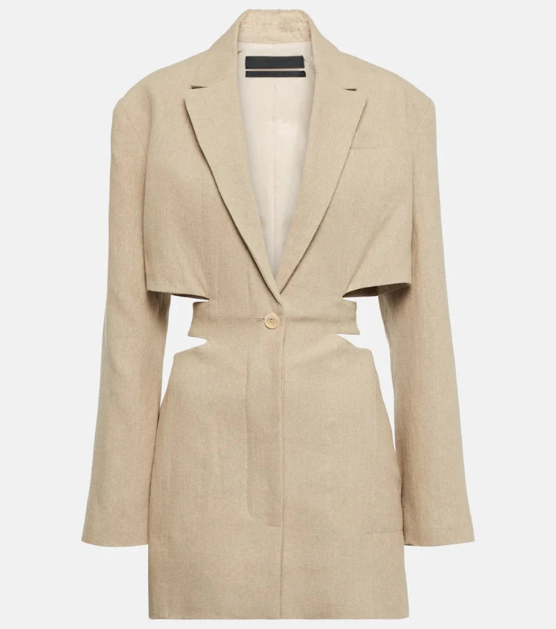 Woman wearing a beige cut-out blazer dress with V-neck, long sleeves, and tailored fit. Side cut-outs and single-button closure complete the chic design.