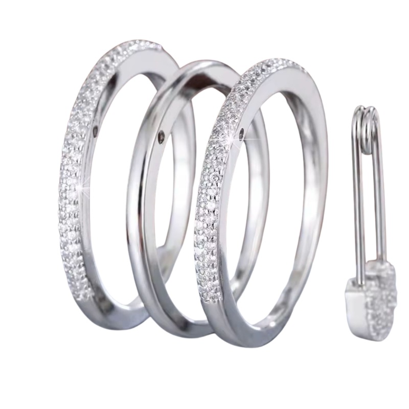 Stacked silver rings with dazzling crystals and a unique safety pin lock