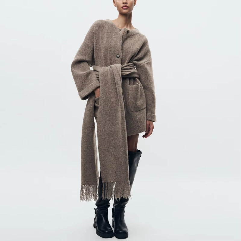 Elegant beige wool blend coat with attached scarf, single-breasted design and oversized silhouette for fall winter 2025.