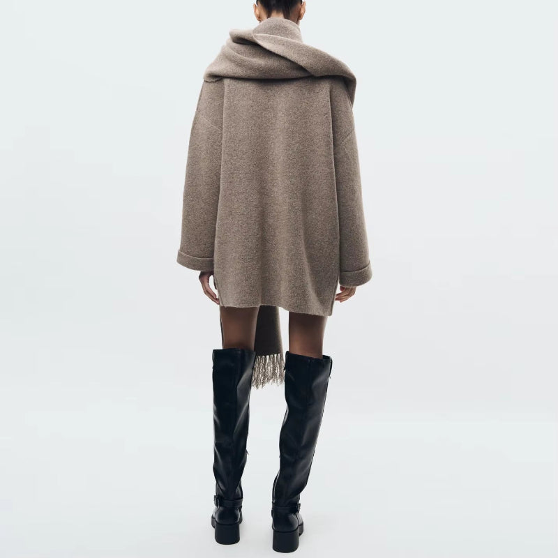 Elegant beige wool blend coat with attached scarf, single-breasted design and oversized silhouette for fall winter 2025.
