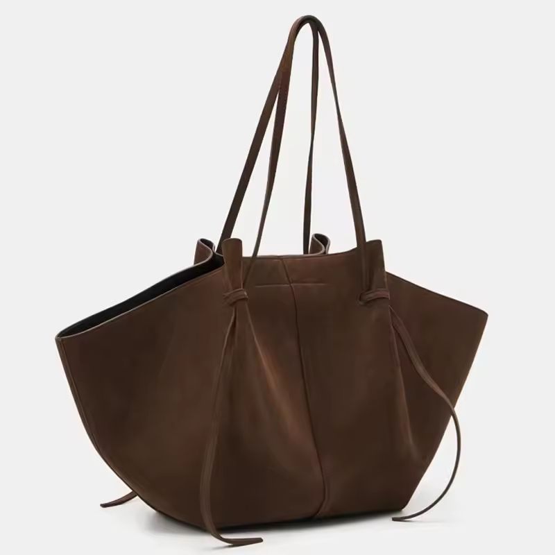 Side and detail view of Milano Luxe Suede Tote in rich brown vegan suede, showcasing stitching and knot handle design
