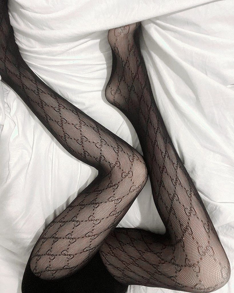 Black sheer monogram tights — premium mesh stockings with luxury geometric detail.