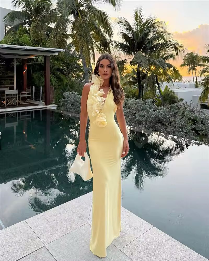 Noa yellow halter dress 2025 – floor-length backless gown with ruffle neckline, A-line silhouette, soft stretch polyester-spandex fabric. Elegant summer outfit for beach weddings, club nights, luxury vacations & golden hour events.