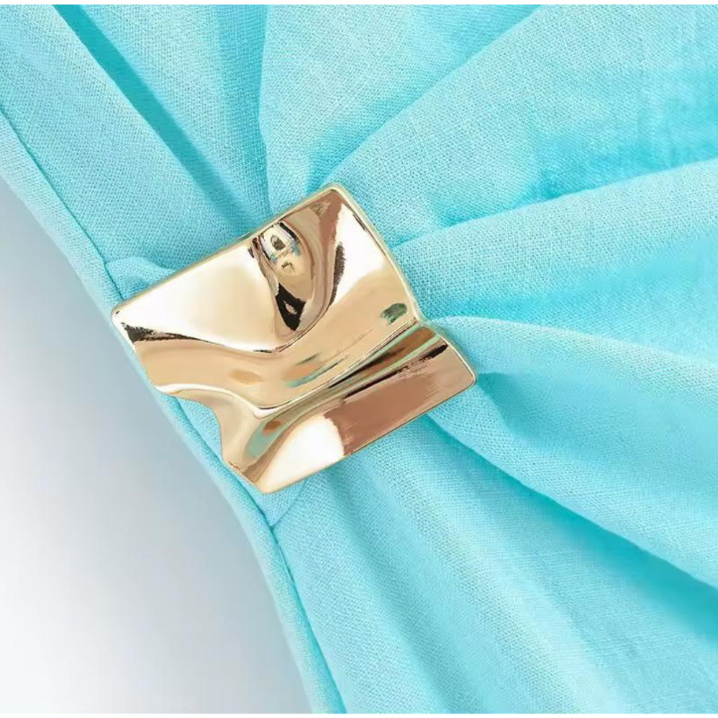 Gold knot side detail on asymmetric sleeveless linen dress, elegant waist accent, turquoise midi fashion dress, 2025 vacation style for women