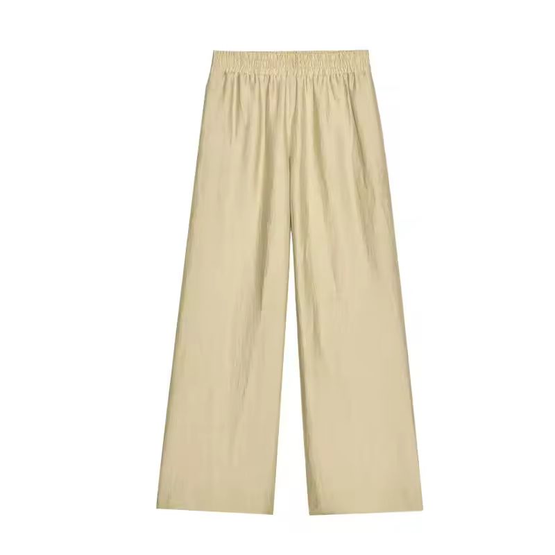 Beige spring/summer outfit – relaxed wide leg pants with tie waist shirt, perfect for travel