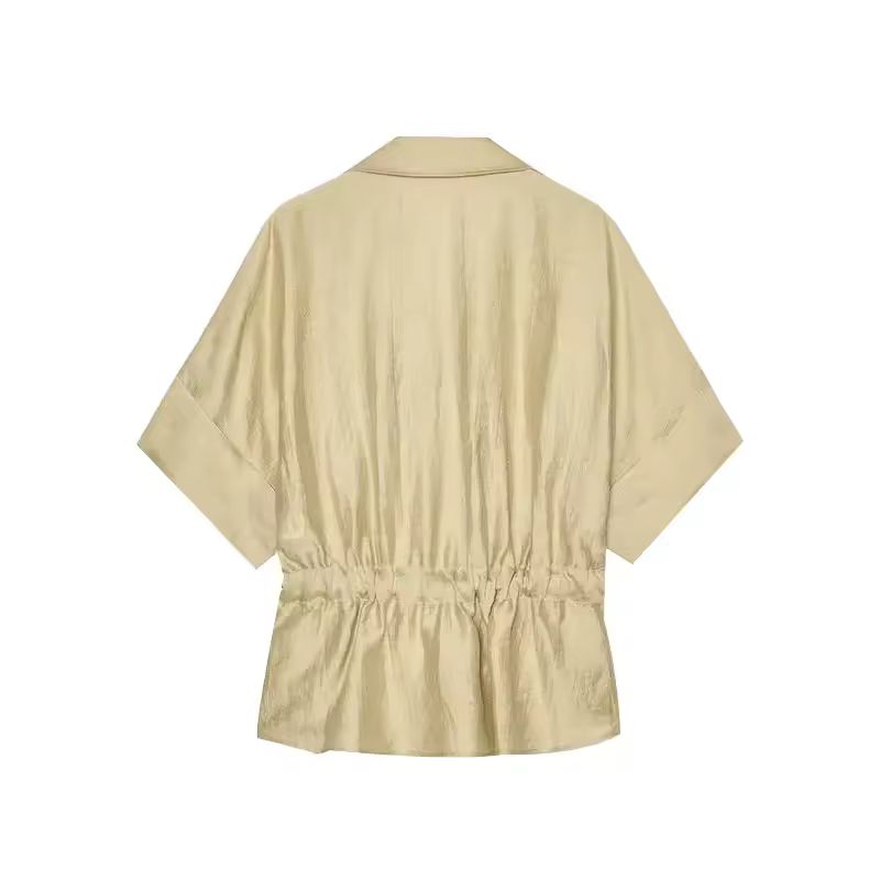 Beige spring/summer outfit – relaxed wide leg pants with tie waist shirt, perfect for travel