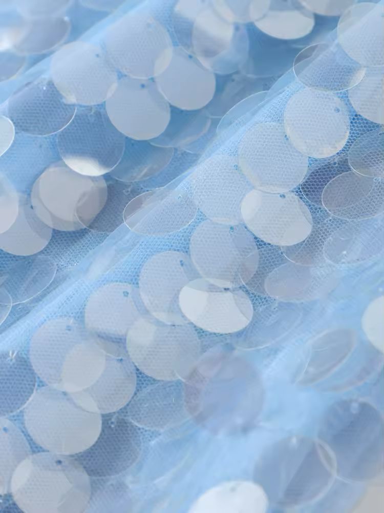 Shimmering sequin and linen-polyester fabric blend in light blue, airy and luxurious texture.