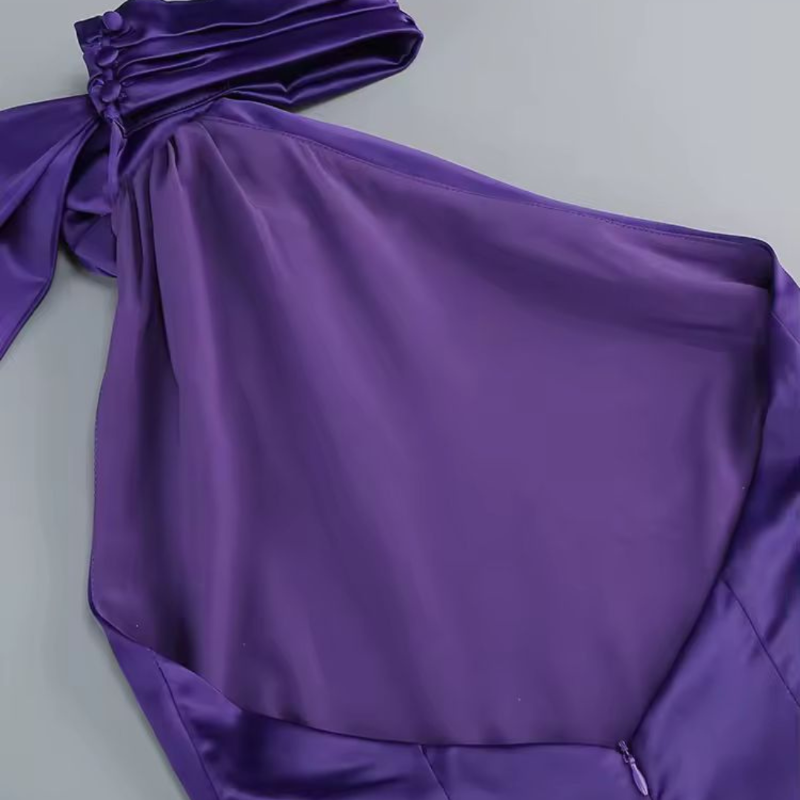 Close-up of 3D flower embellishment on halter neck satin dress – elegant party wear