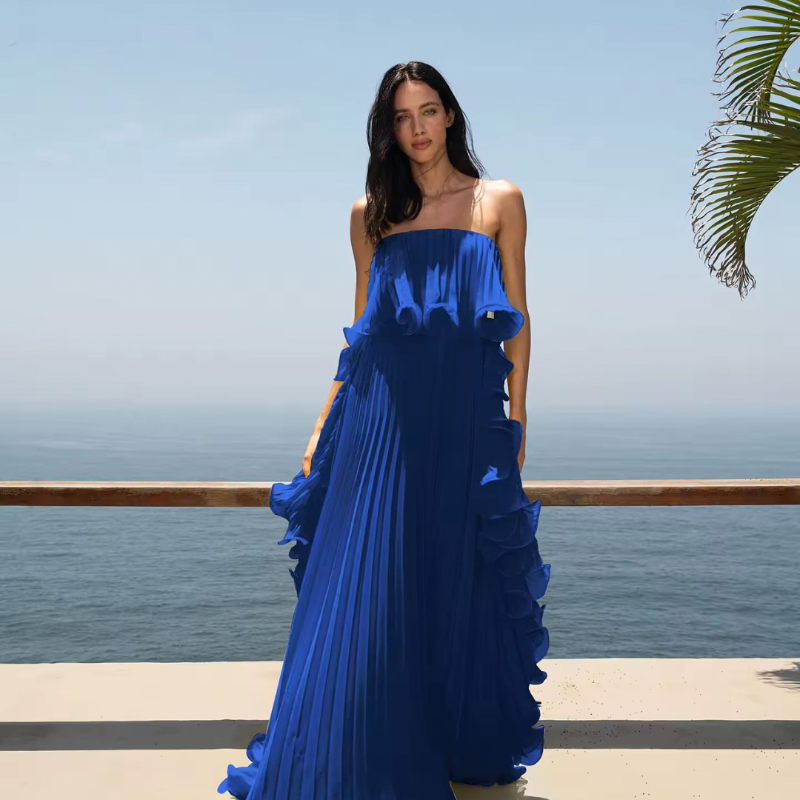 Woman wearing strapless ruffled maxi dress in yellow – Chic & Charm Ibiza Breeze summer collection.