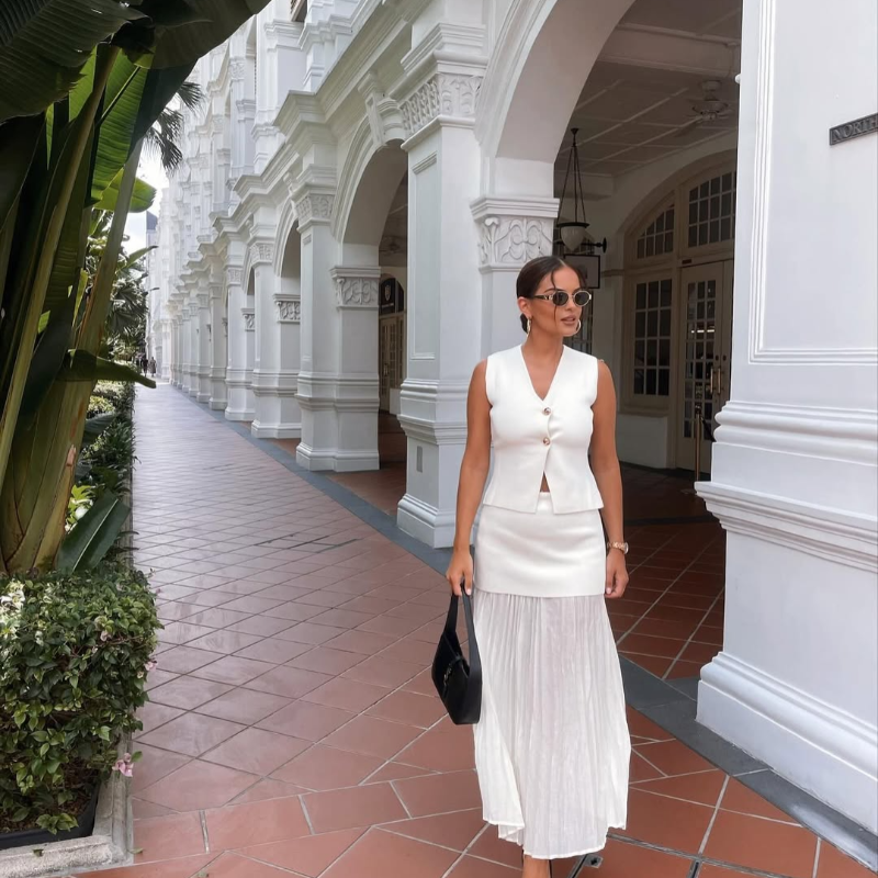 Paris City Muse white two-piece set for women – chic sleeveless vest and plissé maxi skirt – stylish choice for weddings, vacations, and special occasions.