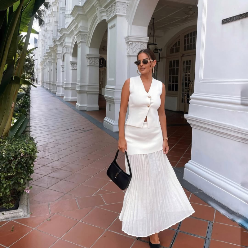 Paris City Muse white two-piece set for women – chic sleeveless vest and plissé maxi skirt – stylish choice for weddings, vacations, and special occasions.