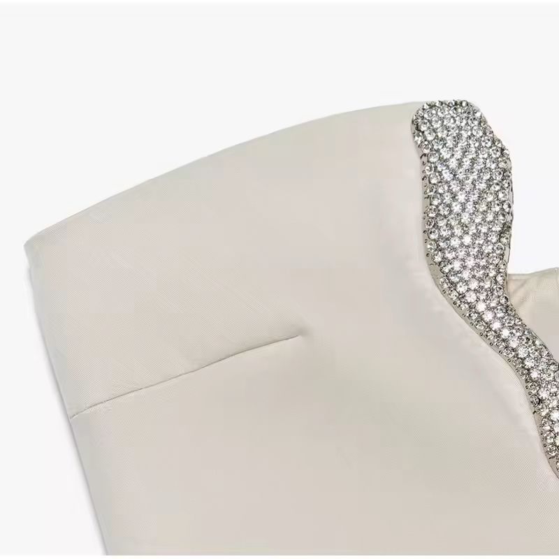 Side view of beige strapless cocktail dress with shimmering rhinestone neckline and short hemline