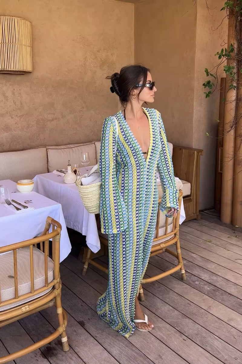 Stylish beachwear outfit with patterned dress, wide-brim hat, and woven green bag – seaside fashion online