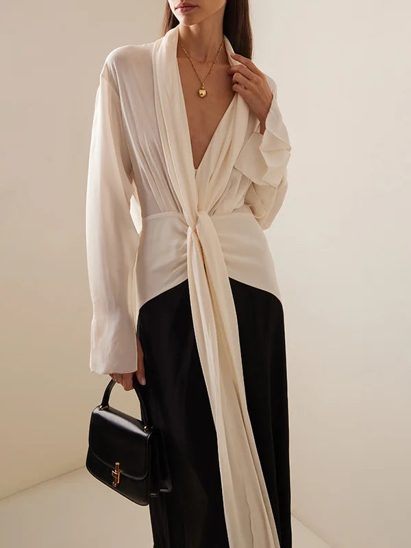 Open-back long sleeve formal dress with black side panels and ivory draped back – sleek and refined look