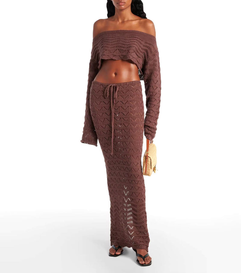 Two-piece Sahara Boho crochet outfit for women in white and brown, featuring an off-shoulder long sleeve crop top and high-waisted maxi skirt with drawstring, perfect for beachwear, festivals, and summer vacations