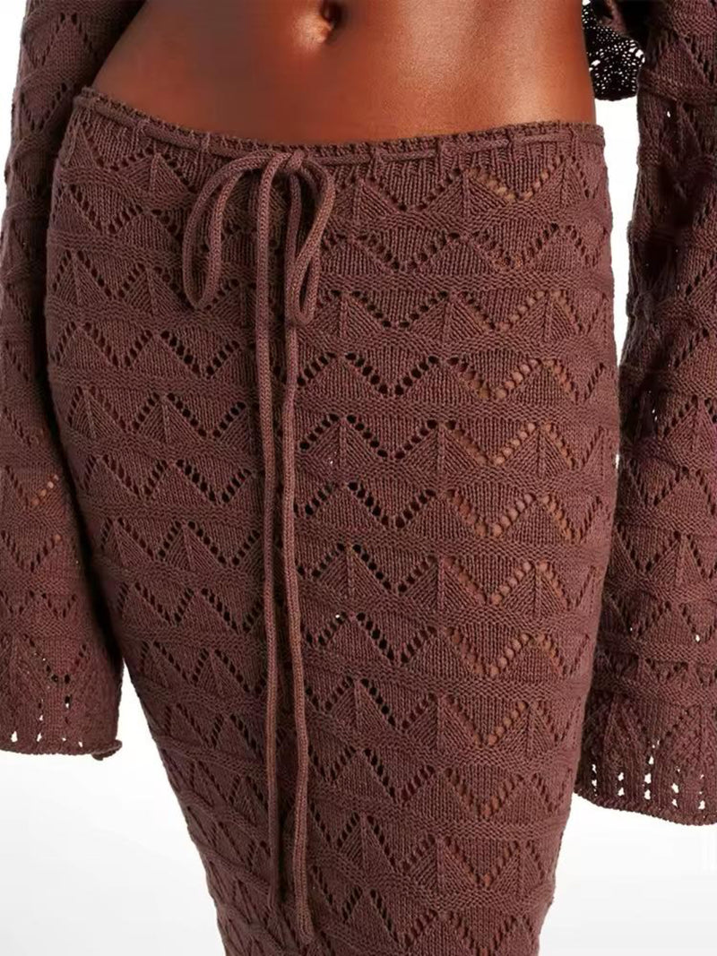 Close-up of Sahara Boho high-waisted maxi skirt with adjustable drawstring and side slit, showcasing lightweight crochet fabric in white and brown.