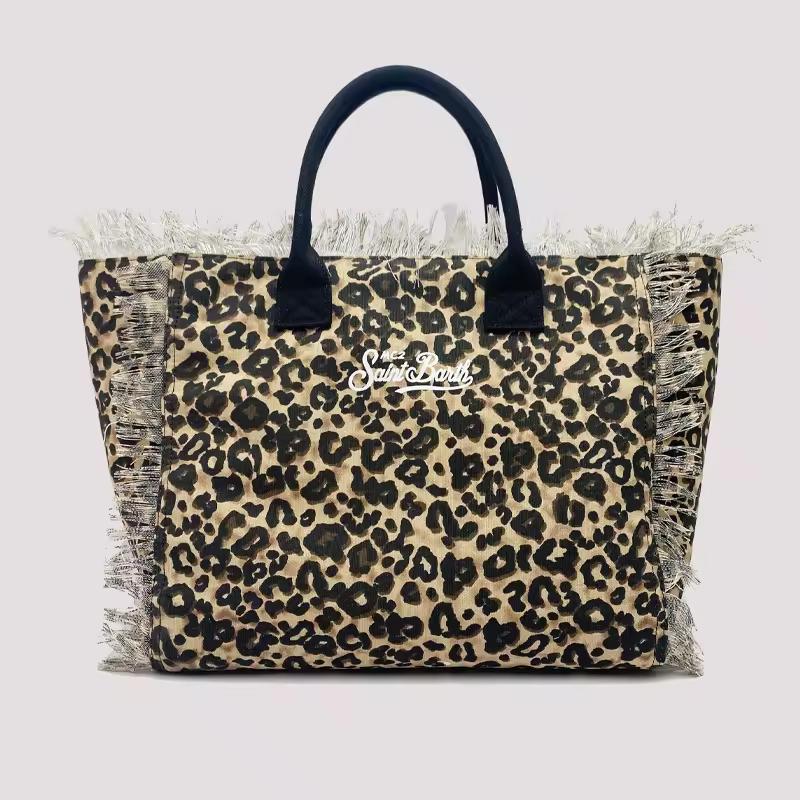 Saint Barth beach bags in hot pink, leopard print, ivory and natural straw – colorful canvas totes with boho vibe for summer 2025.