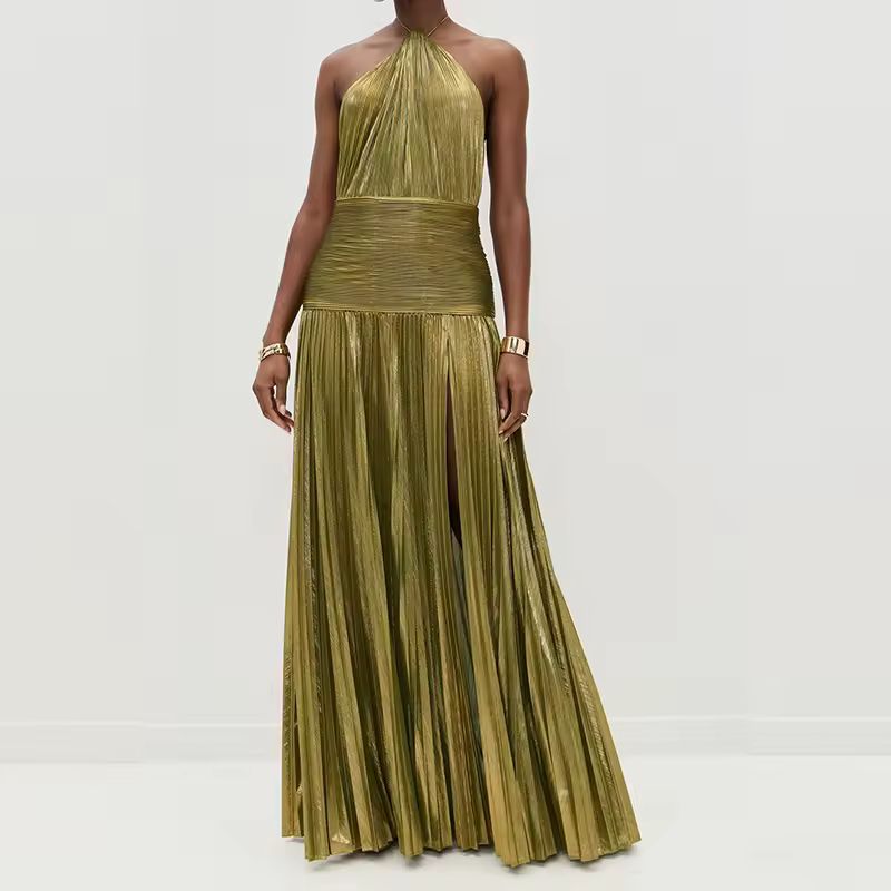 Model wearing a shimmering gold-olive pleated halter neck maxi dress with high slit and ruched waistband, styled with gold jewelry and platform heels – front view.