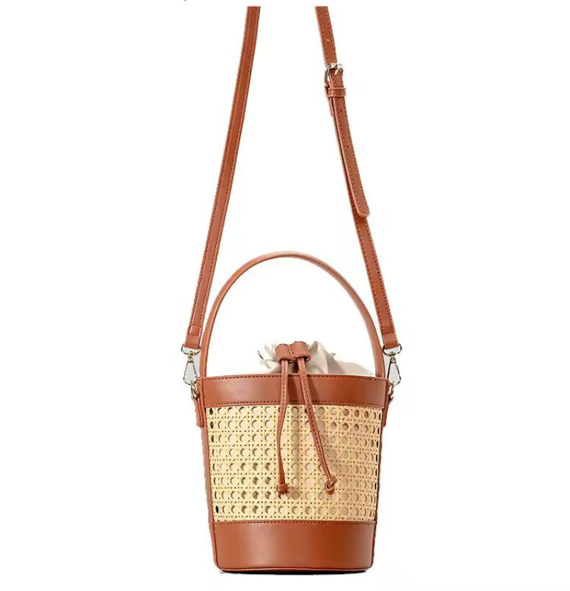 The CORA Straw Shoulder Bag styled on a picnic setup – the perfect accessory for beach days, weekend getaways and vacation looks.