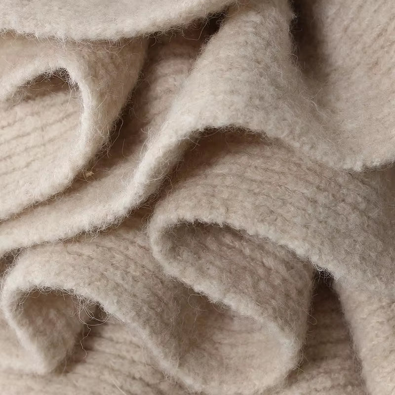 Elegant women’s knitwear set in beige – long wool blend coat, turtleneck sweater and midi skirt with ruffle detail, autumn winter fashion outfit.
