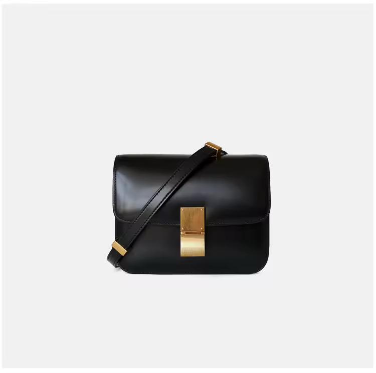 Elegant black genuine leather shoulder bag with gold clasp and adjustable strap — timeless minimalist handbag for everyday wear.