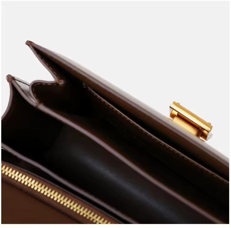 Classic cognac brown leather shoulder bag with gold clasp and soft texture — warm-toned minimalist leather accessory for fall and winter.