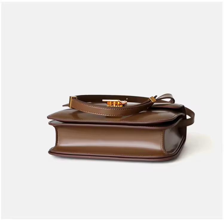Brown genuine leather crossbody with gold clasp and modern design — luxury everyday bag for women, versatile and chic.